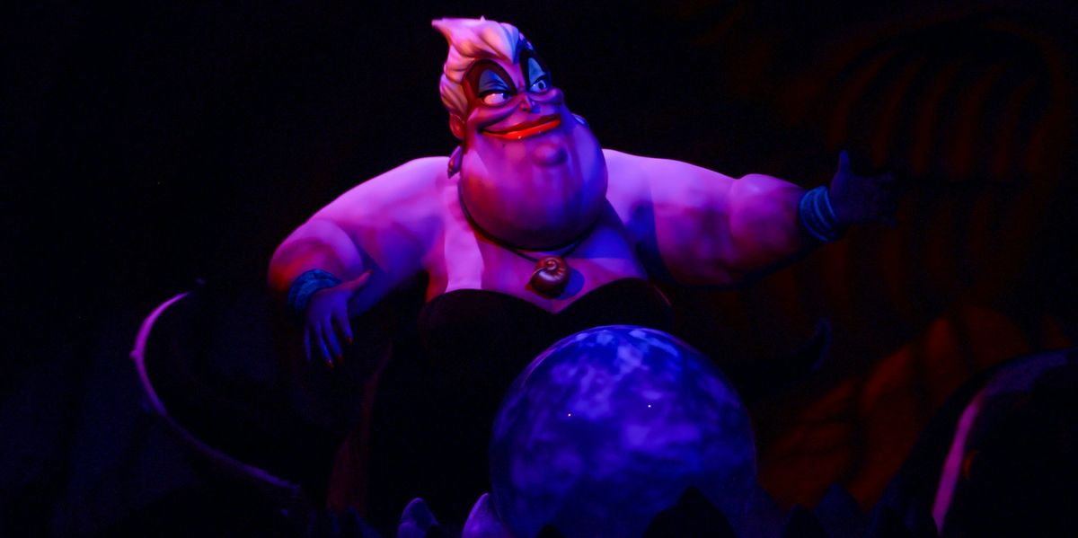 A photo of Ursula from "The Little Mermaid." She is smiling and floating against a black background. 