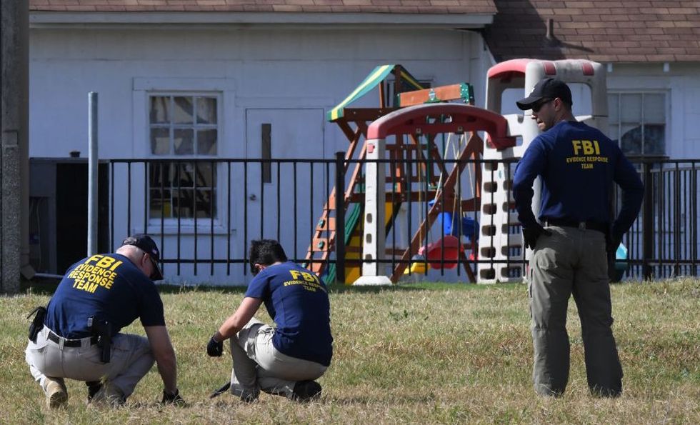 FBI agents search for clues at the First Baptist Church after mass shooting killed 26 people in Sutherland Springs, Texas on November 6, 2017.