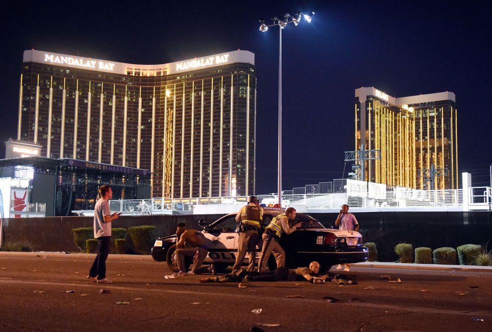 Las Vegas police stand guard along the streets outside the Route 91 Harvest Country music festival grounds